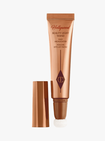 Charlotte Tilbury Beauty Light Wand Highlighter in branded tube component on a light gray background